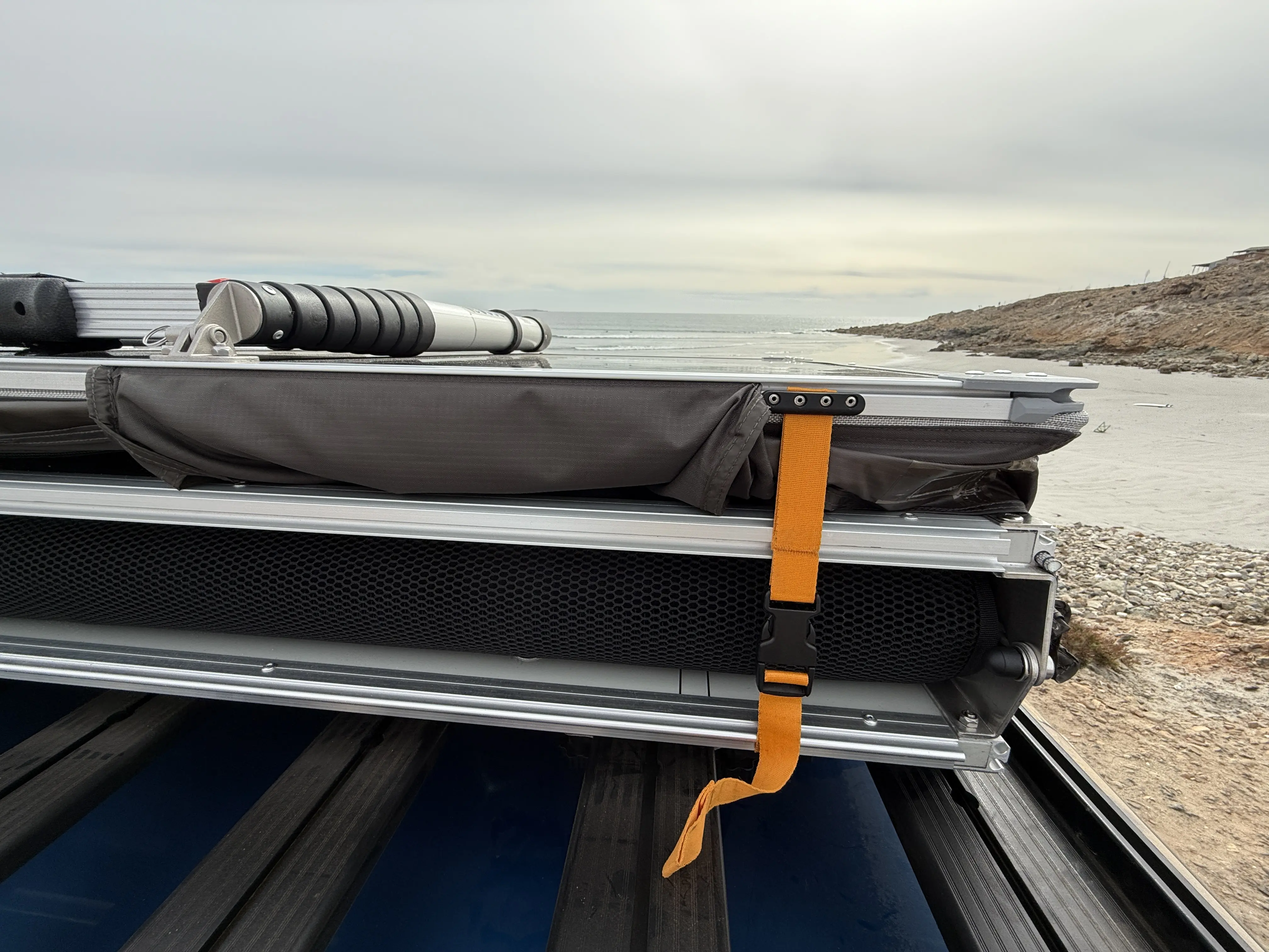 Dometic TRT 140 Air Inflatable Rooftop Tent folded up into thirds and buckled 