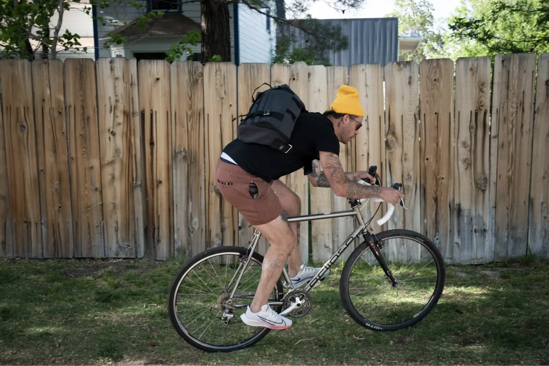 a cyclist wearing the mission workshop monty pedals past