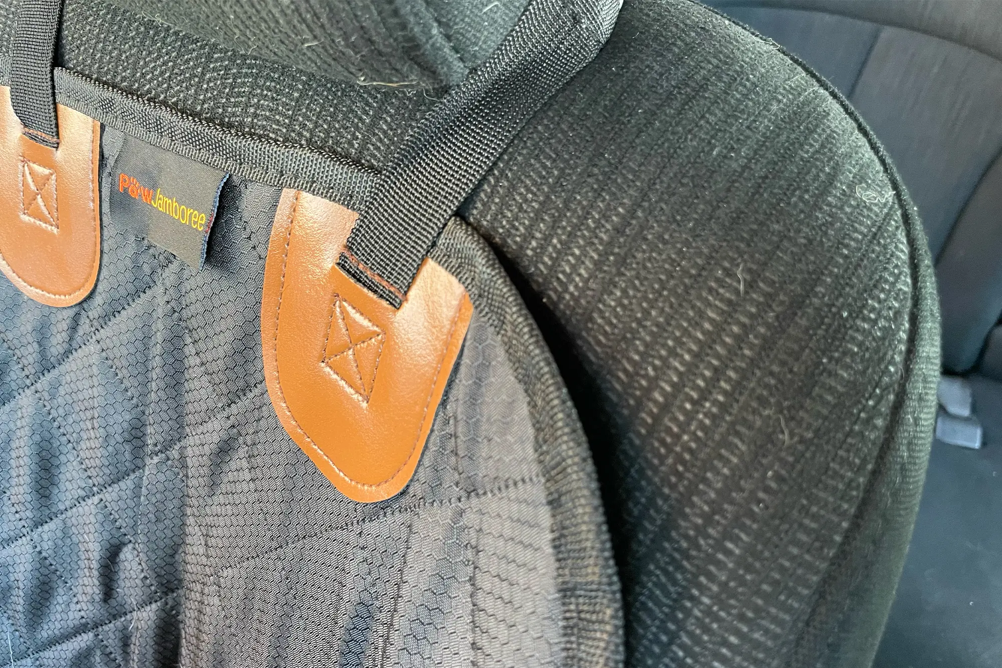 Straps and leather accents secure the Paw Jamboree Car Seat Protector