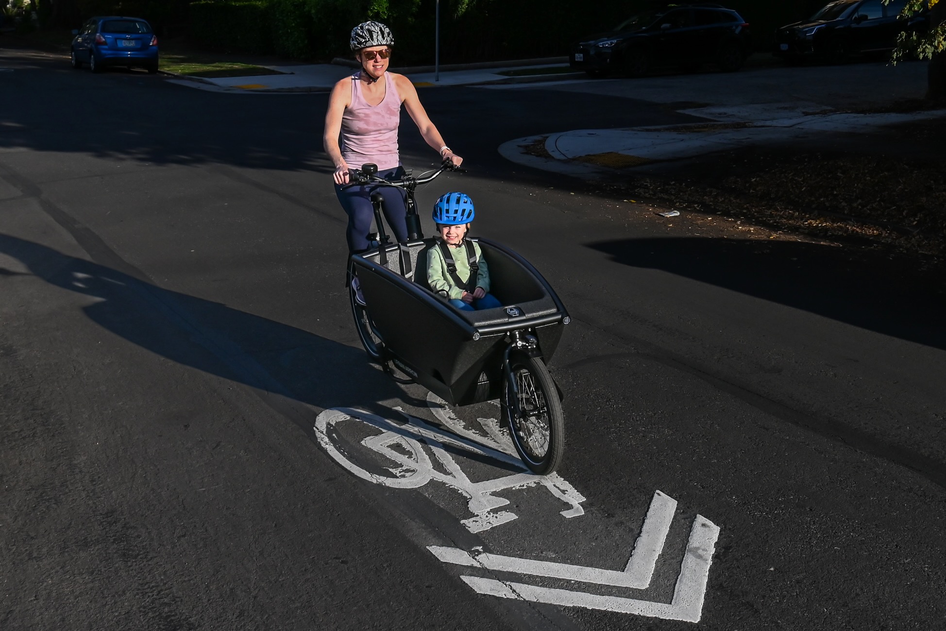Testing the Urban Arrow Family Cargo Line electric cargo bike with a child passenger in the front box.