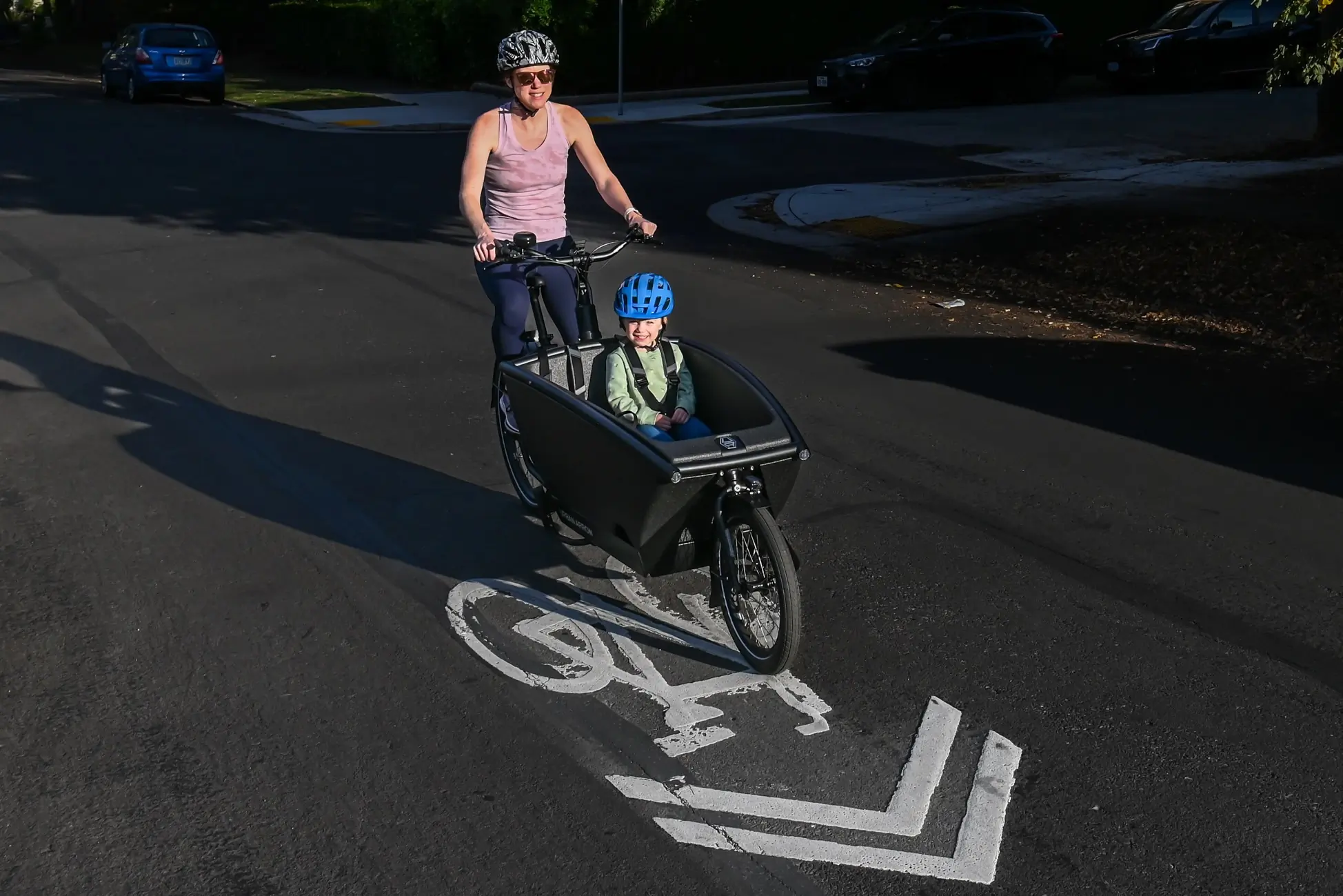 Testing the Urban Arrow Family Cargo Line electric cargo bike with a child passenger in the front box.
