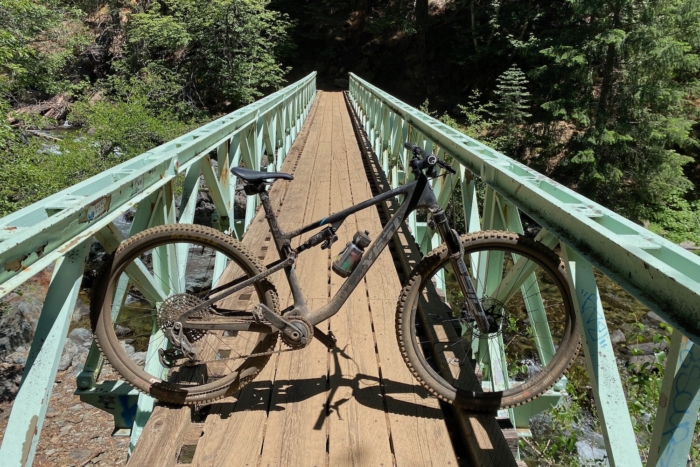 The Yeti ASR parked on a bridge during a mountain bike ride
