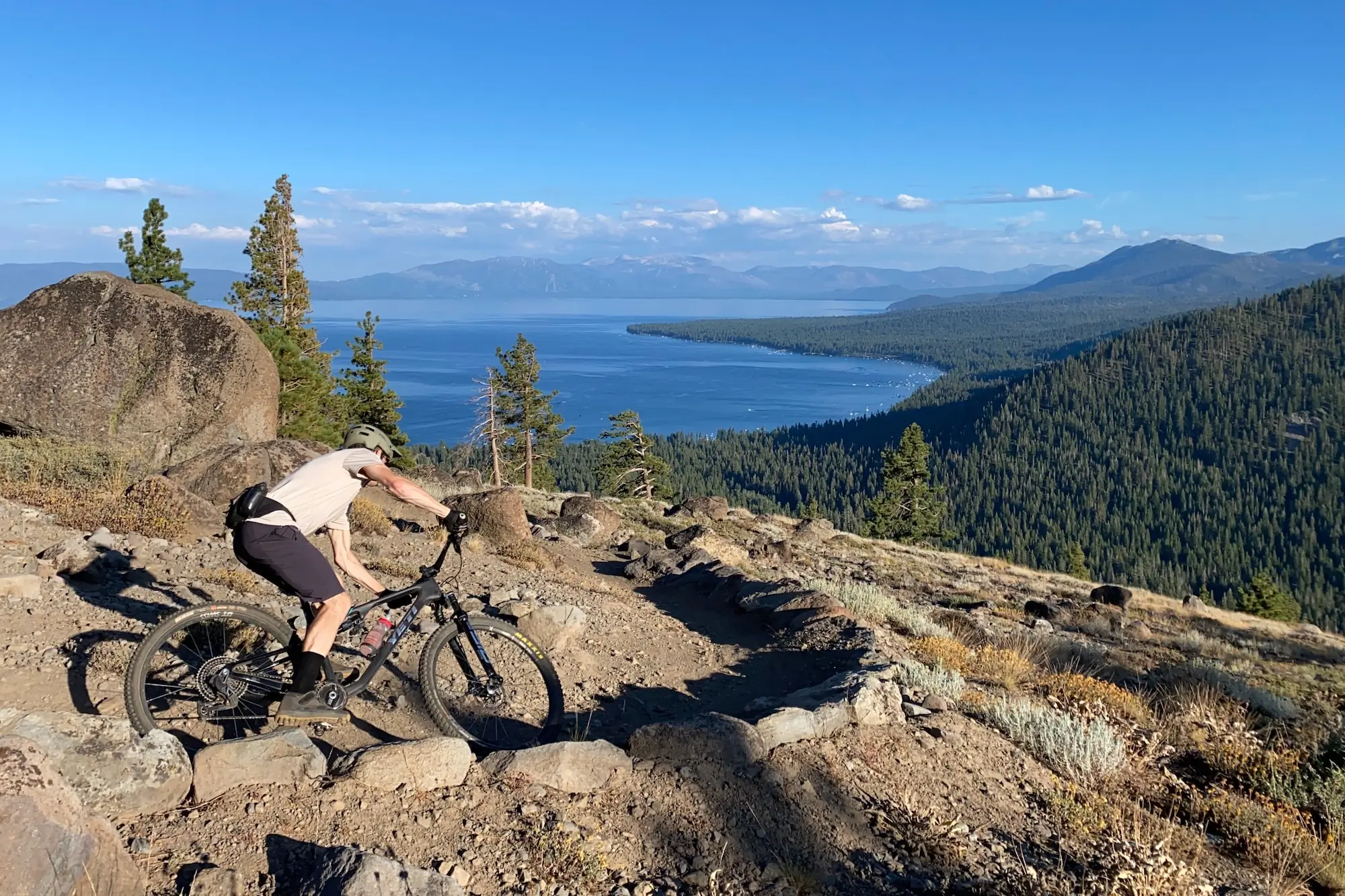 Riding the Yeti ASR around a sweeping turn with Lake Tahoe in the background