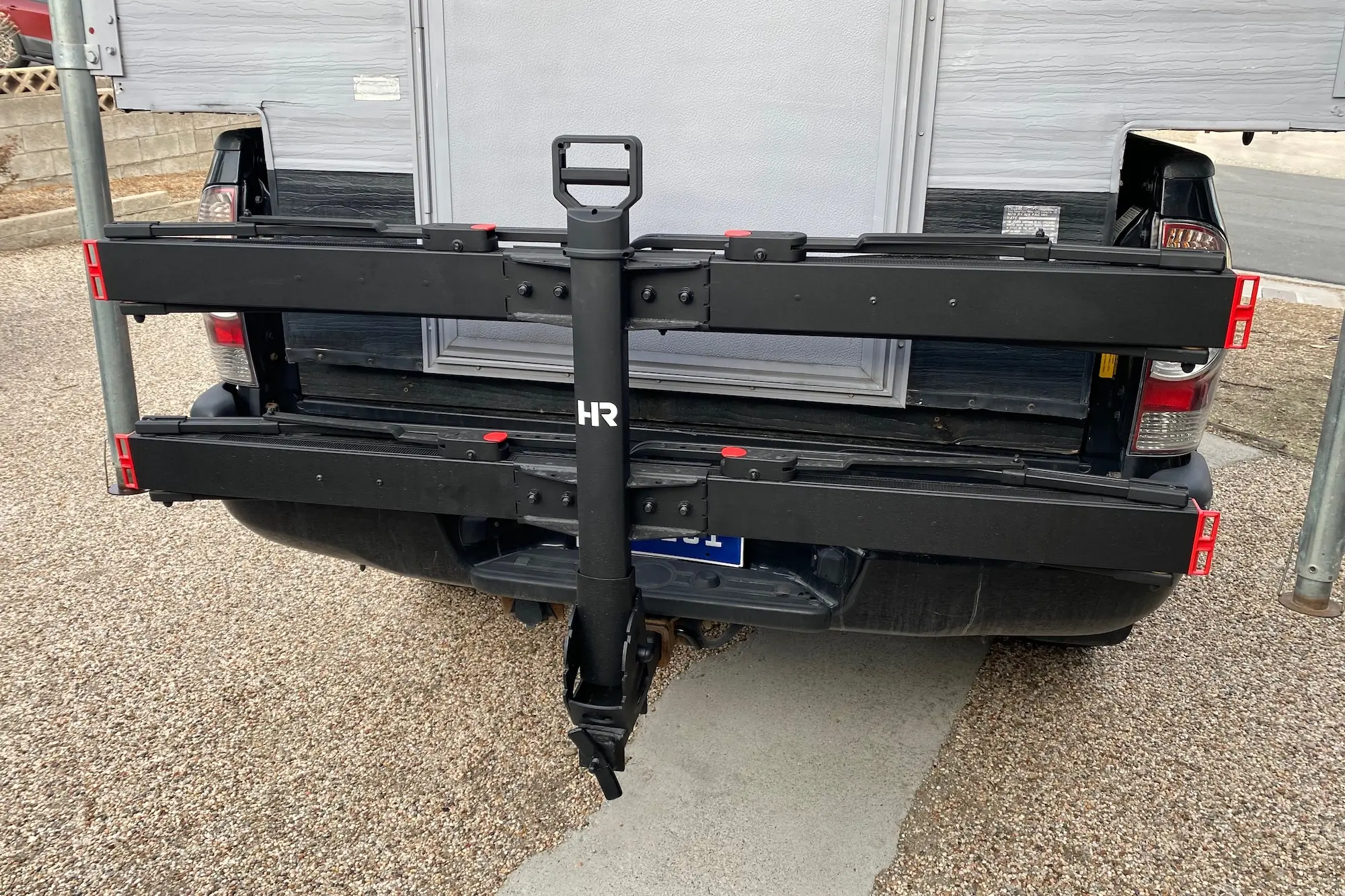 The Hollywood Racks CrossTrack folded up against the back of pickup truck