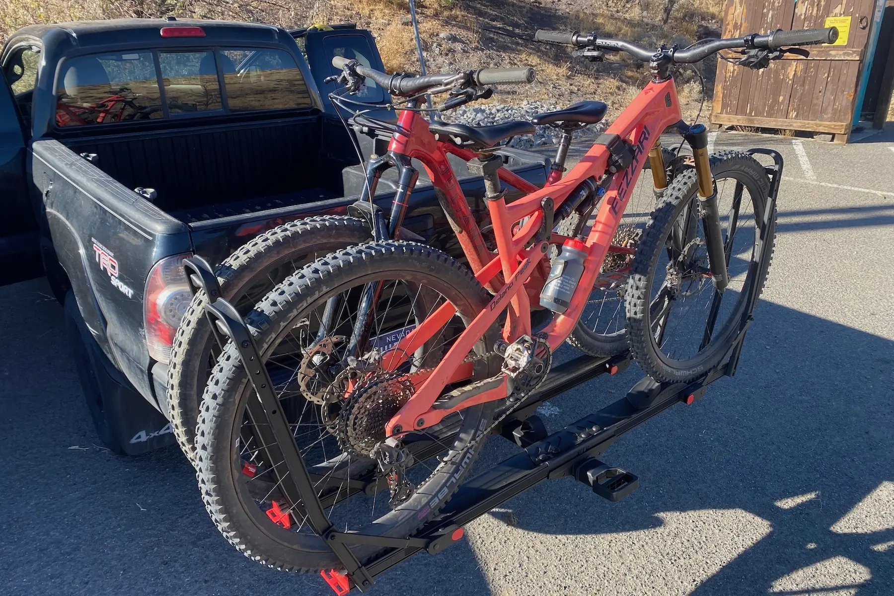 The Hollywood Racks Crosstrack hitch rack carrying 2 mountain bikes and parked at a trailhead