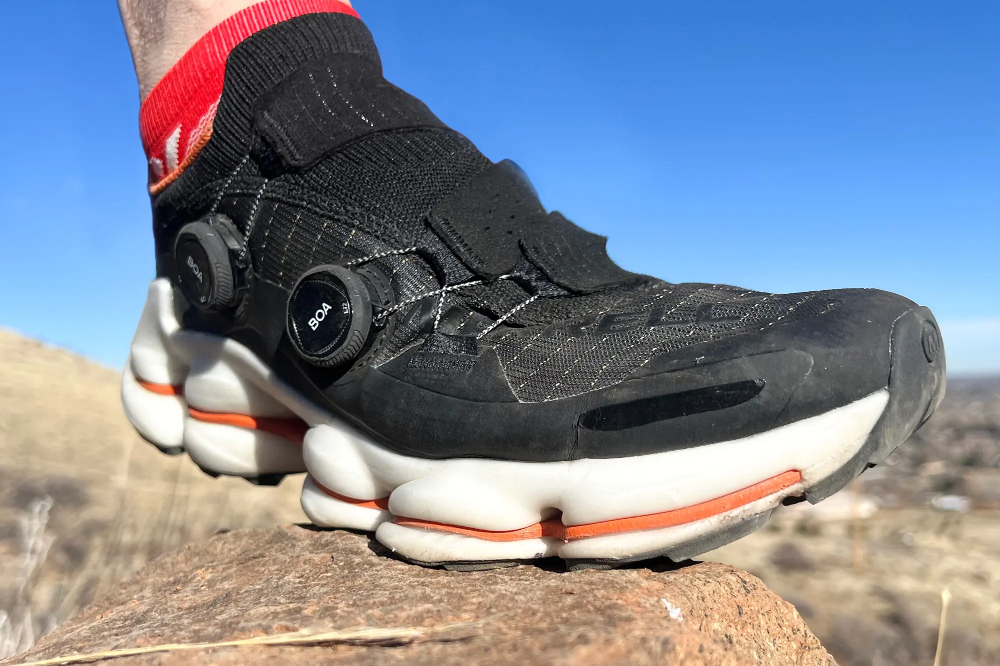 merrell speedarc surge boa stepping onto rock