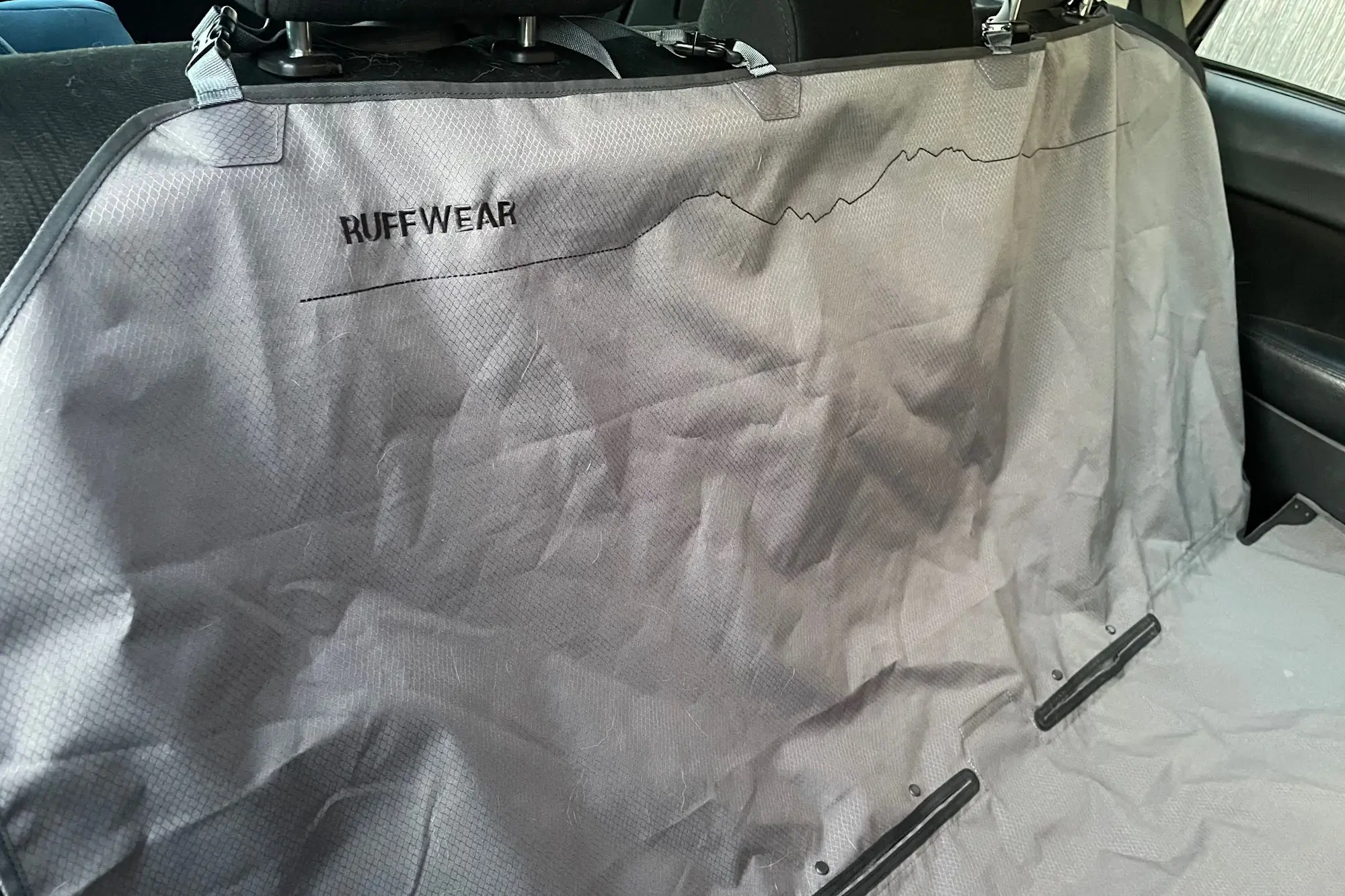 Ruffwear Dirtbag dog seat cover installed on a car backseat