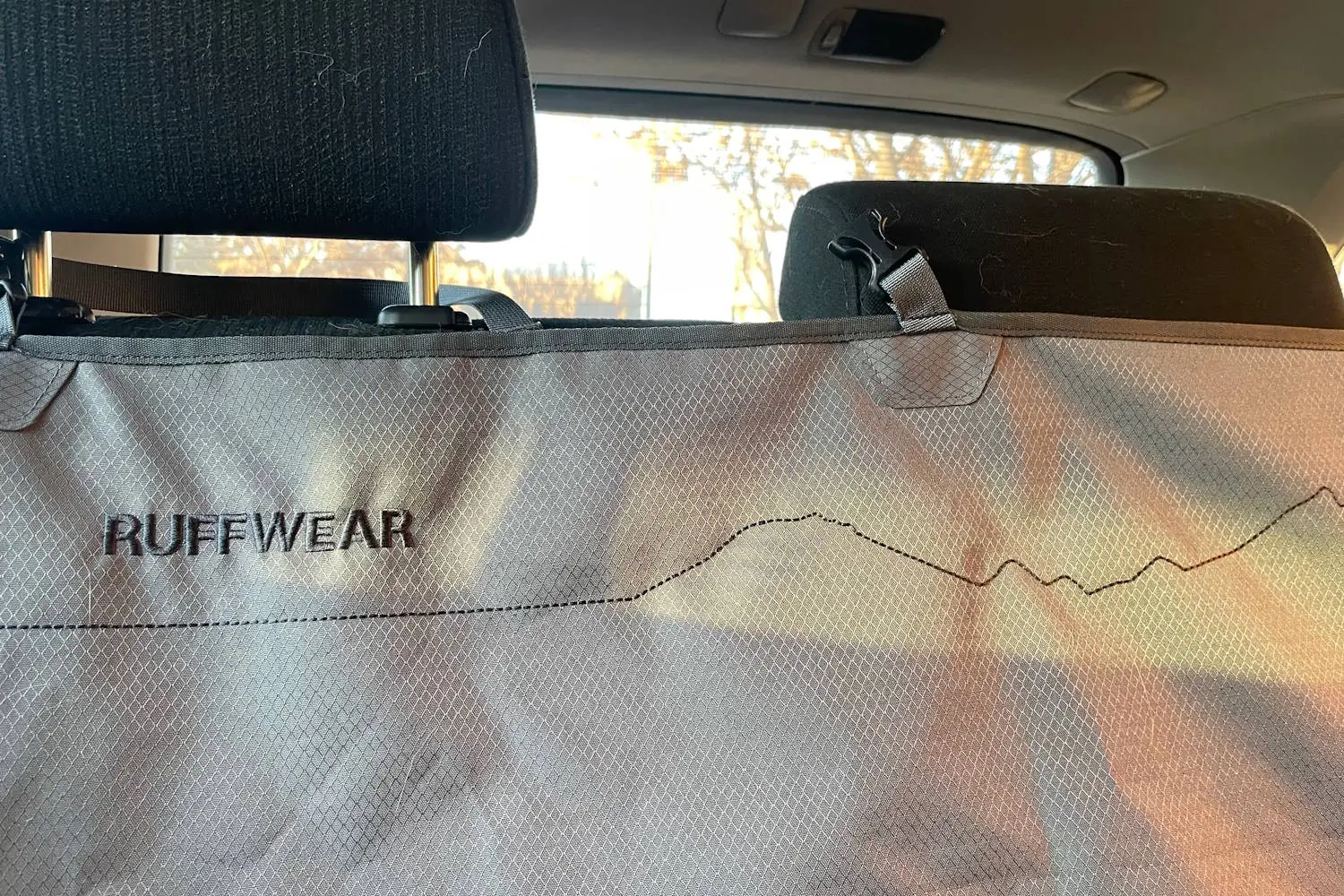 Back seat cover with a stitched mountain silhouette design and 'Ruffwear' branding