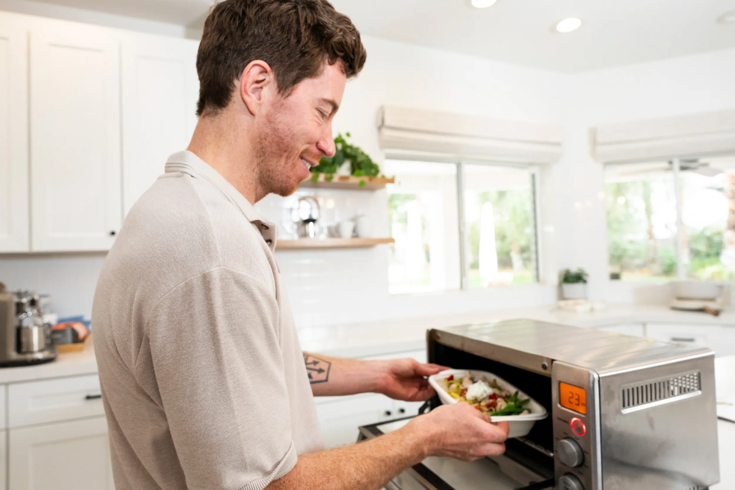 shaun white cooking a cookunity delivery meal in a toaster oven