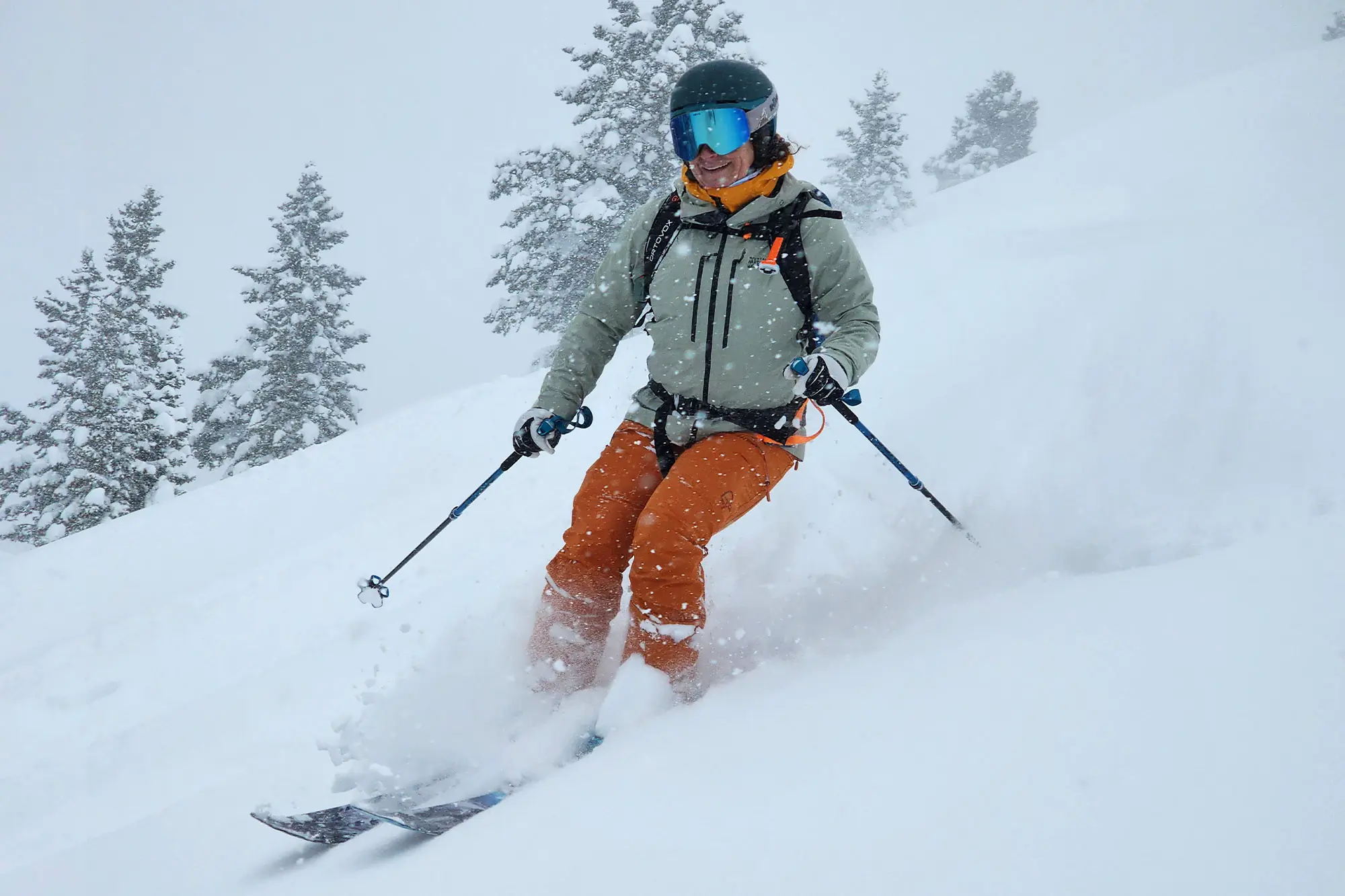 A skier carving through fresh powder, surrounded by snowfall