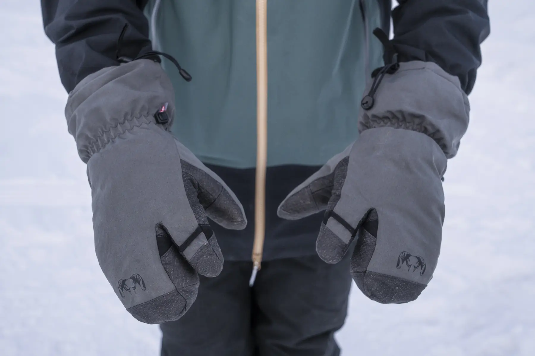 A person extends both gloved hands, displaying their fit and insulation