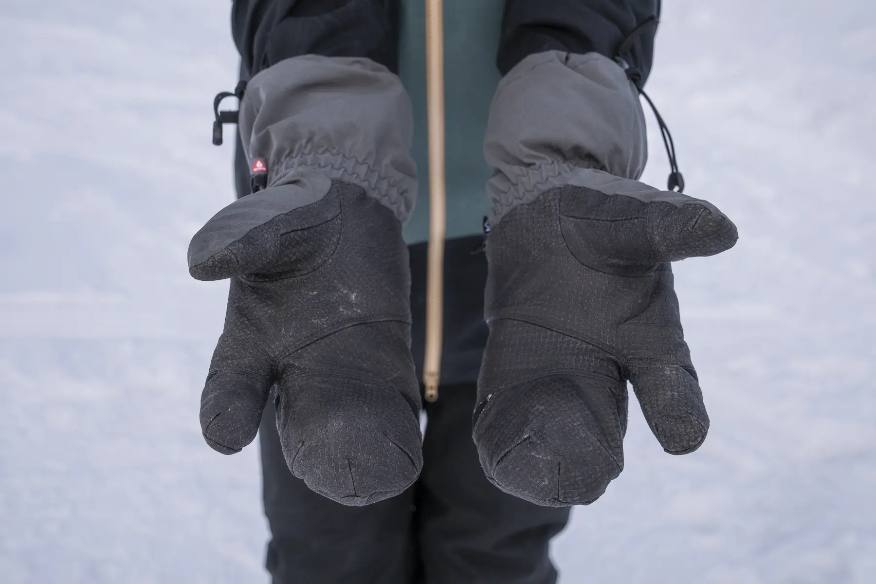 A close-up of gloved hands with visible wear on the palms