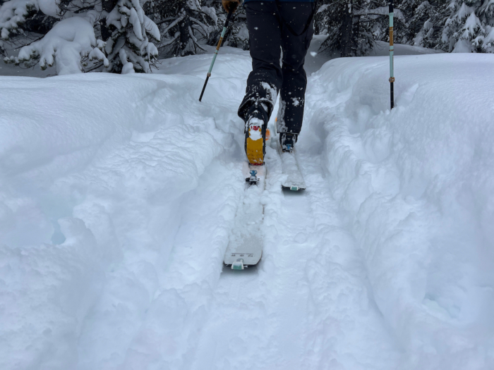 Skinning uphill through deep snow with La Sportiva Kilo boots and skis