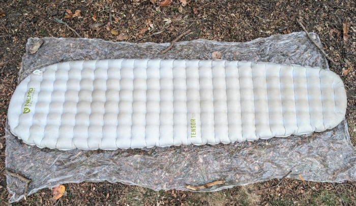 Fully inflated NEMO Tensor Elite Sleeping Pad laid out on a groundsheet