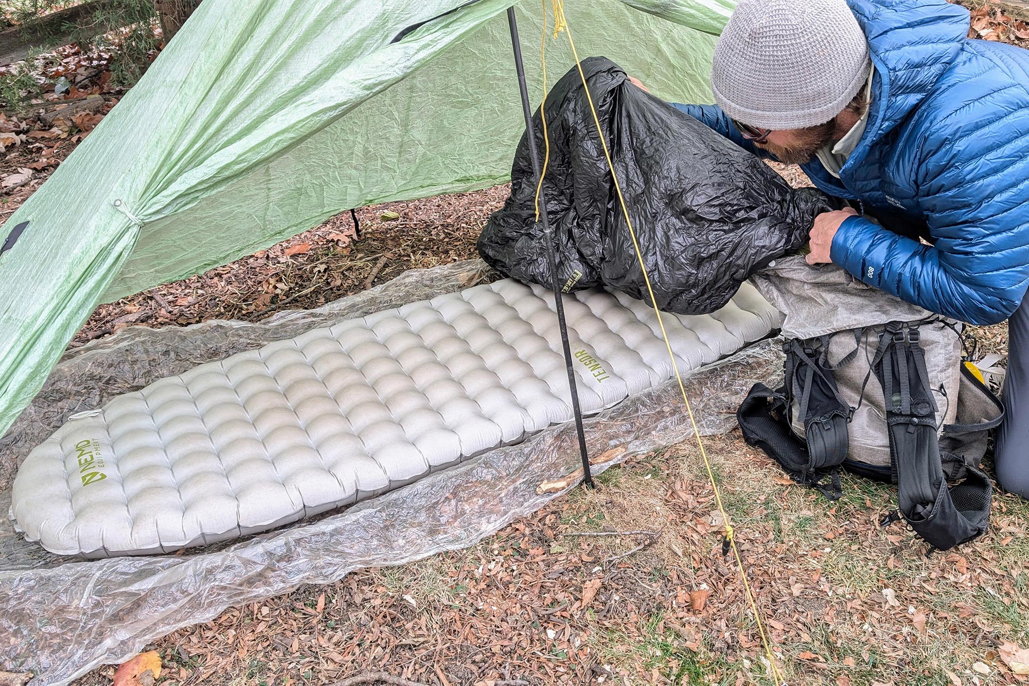 Camper arranging gear next to the NEMO Tensor Elite Sleeping Pad