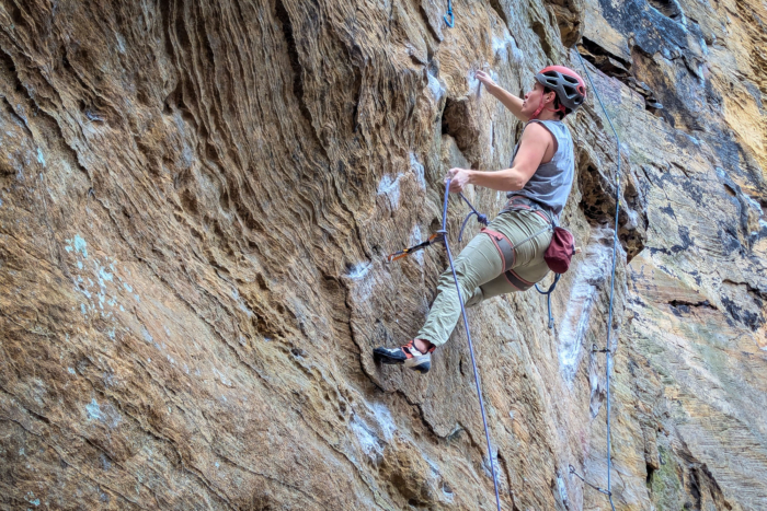 Rock climber clipping a bolt at the Red River Gorge