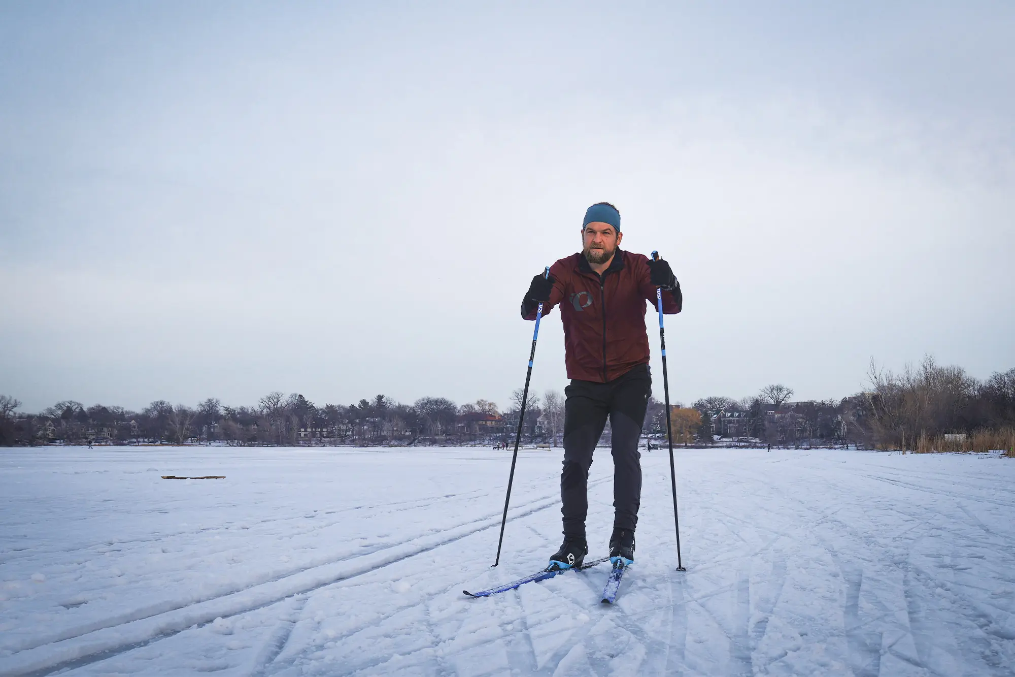 A skier moves across a frozen lake using the Salomon S/Max Skate Kit