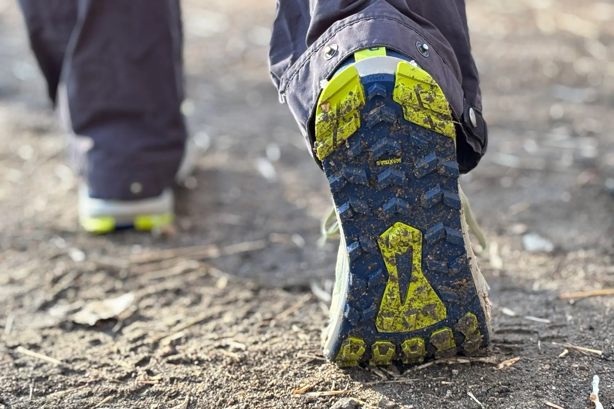The grippy outsole of Altra Lone Peak 9 caked with dirt after a trail run