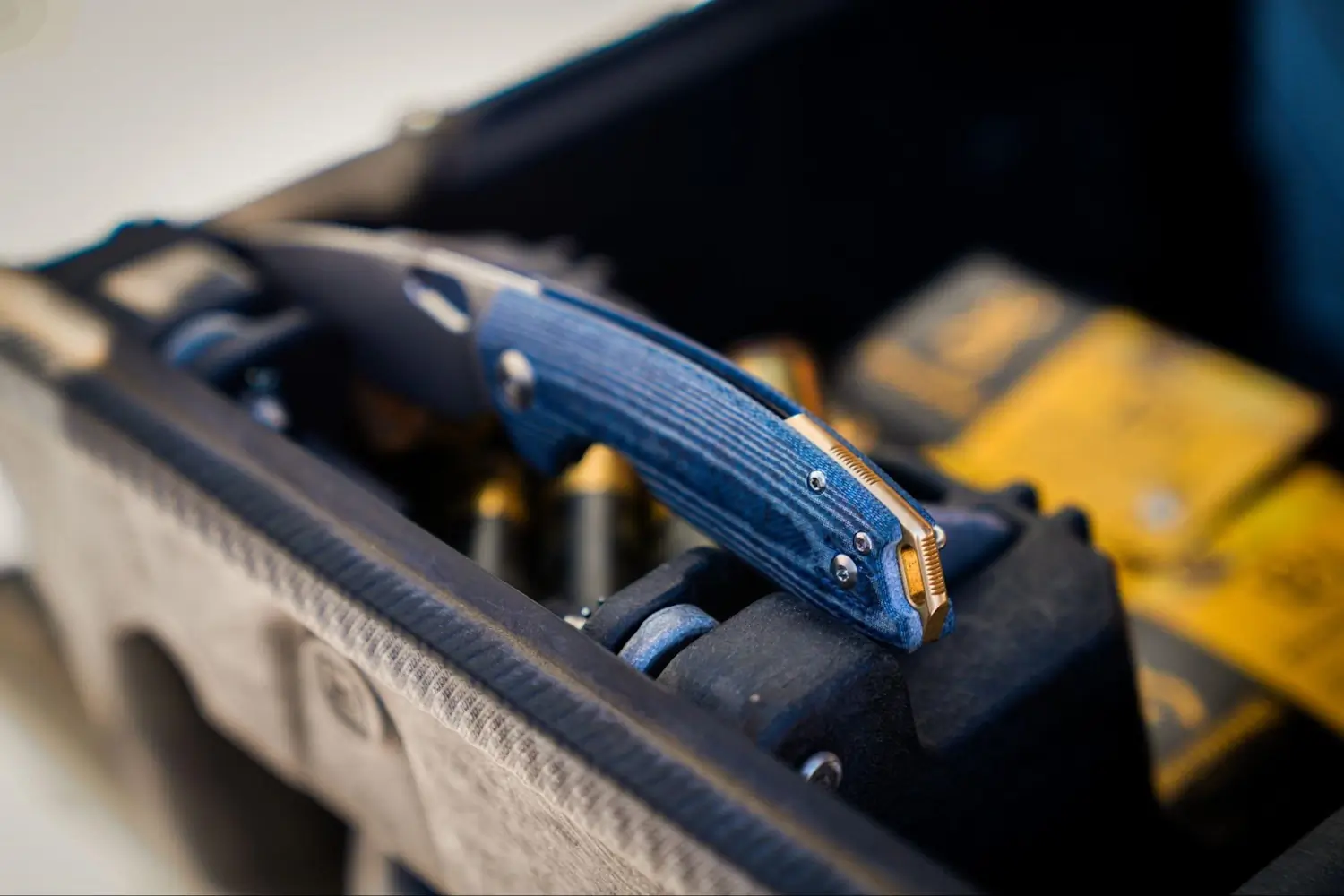 ACE Tribeca Denim Micarta knife resting on a box