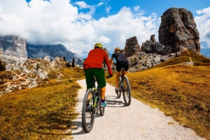 A,Man,And,Woman,Ride,Electric,Mountain,Bikes,In,The