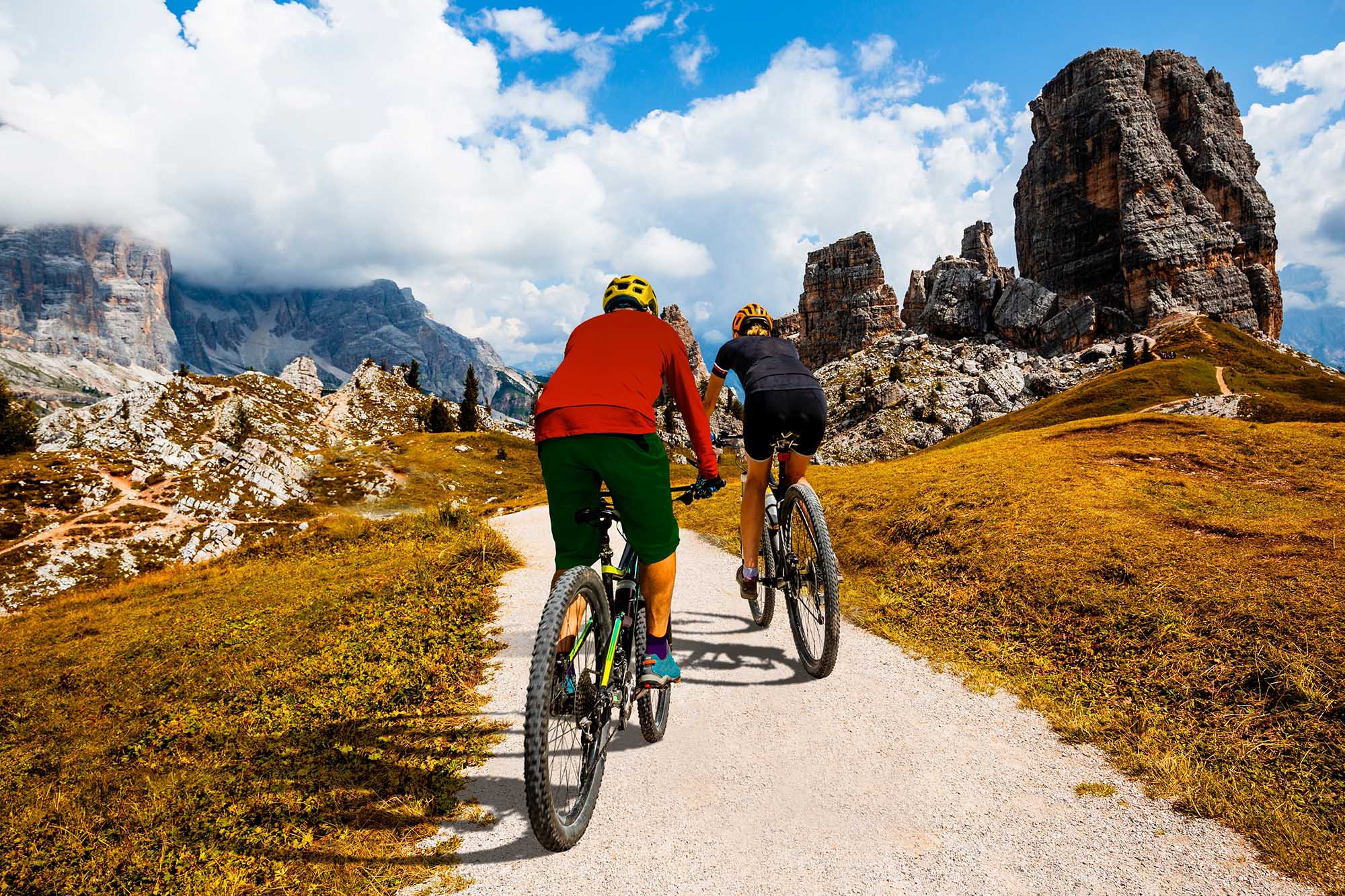 A,Man,And,Woman,Ride,Electric,Mountain,Bikes,In,The