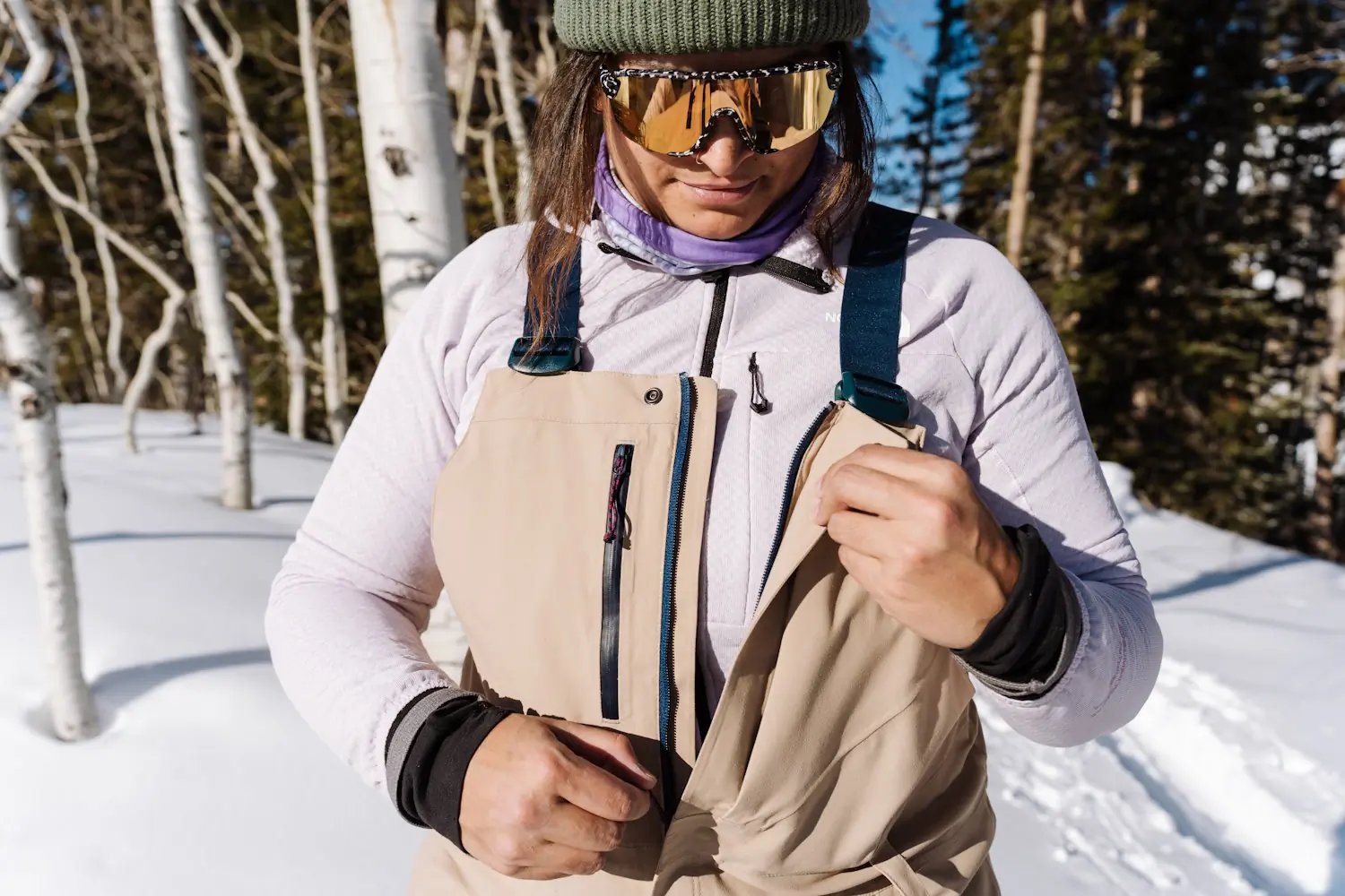 Women unzipping Chariot bib plus chest pocket