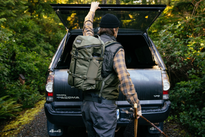 man loading tacoma wearing yeti backpack