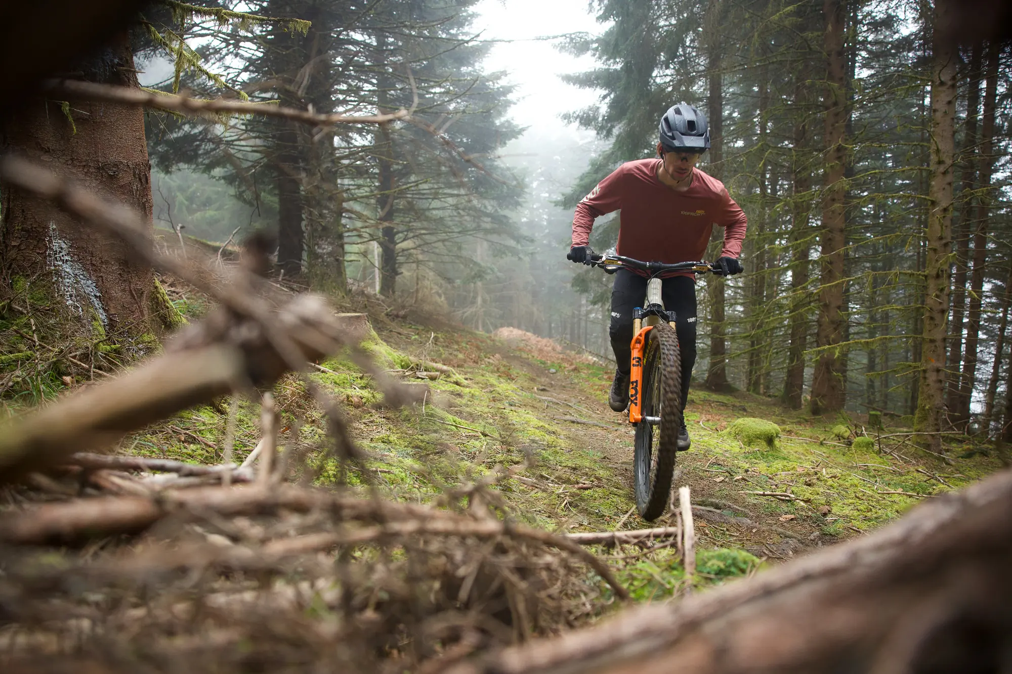 Rider on a Fox 36 SL suspension fork in the woods