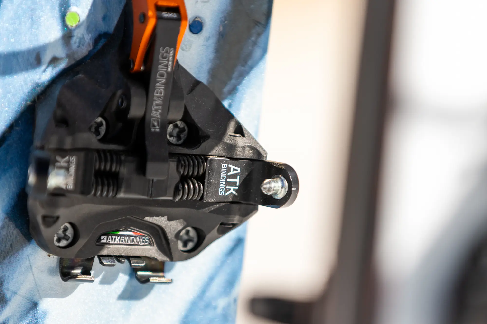 A detailed view of the ATK Raider 13 Evo binding, highlighting its spring-loaded components