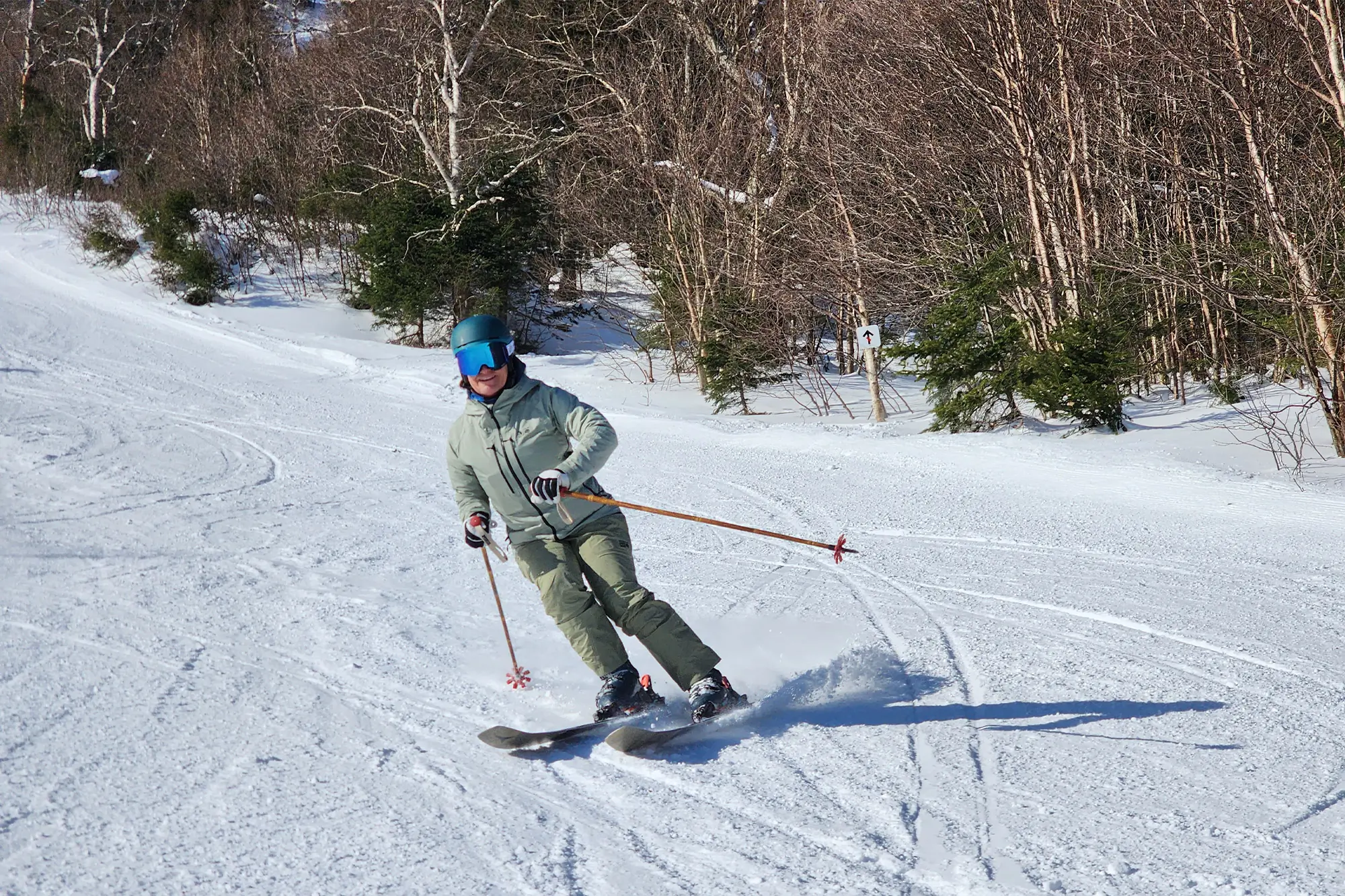 Atomic Maven 103 CTI carving through the snow on a sunny day
