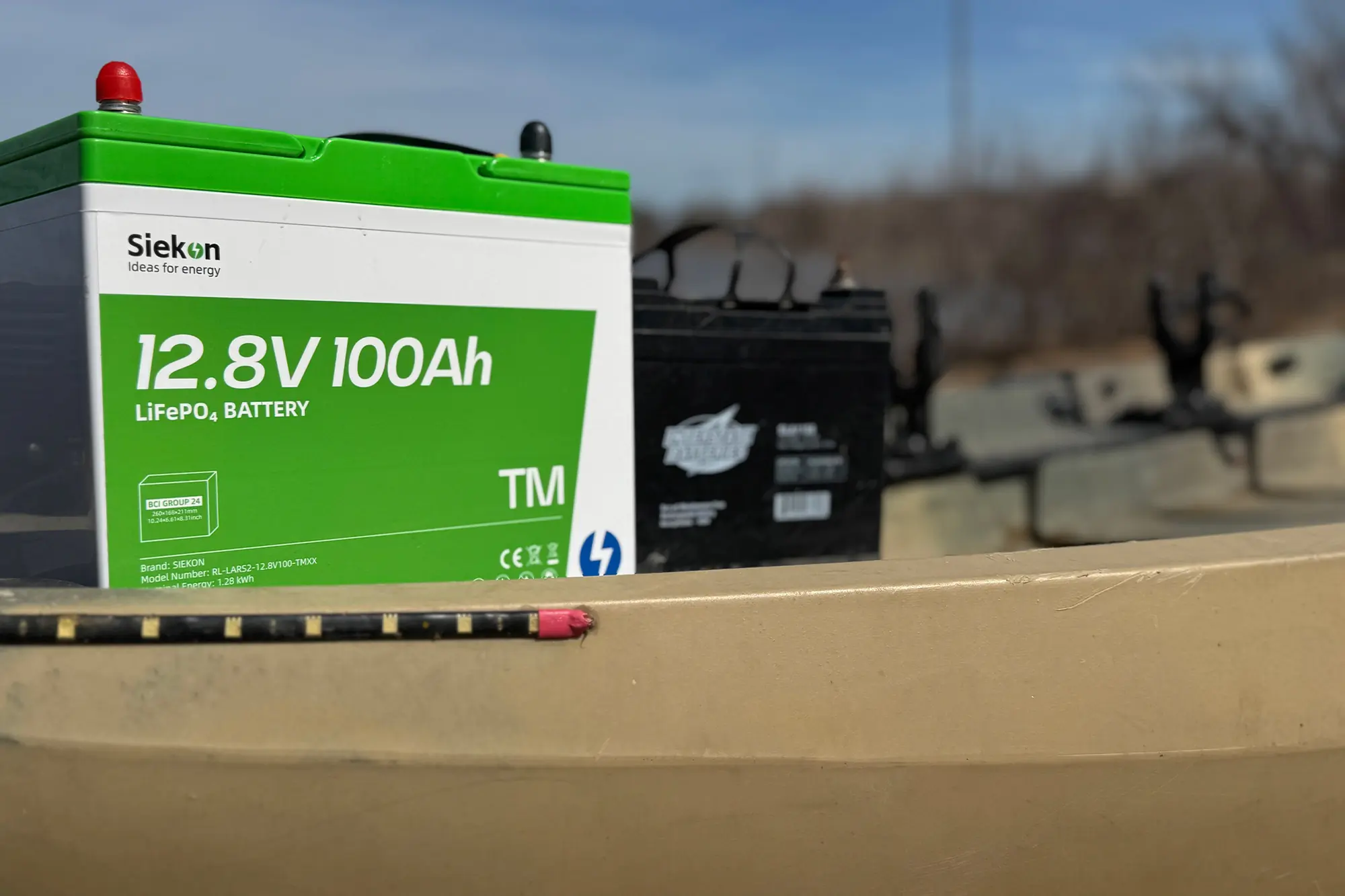 A 12.8V 100Ah battery is placed on the kayak for a reliable power source