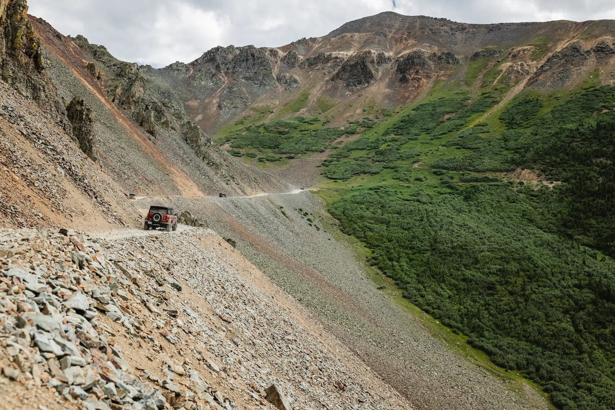 Car driving along gravel road on side of mountain, Telluride CO?