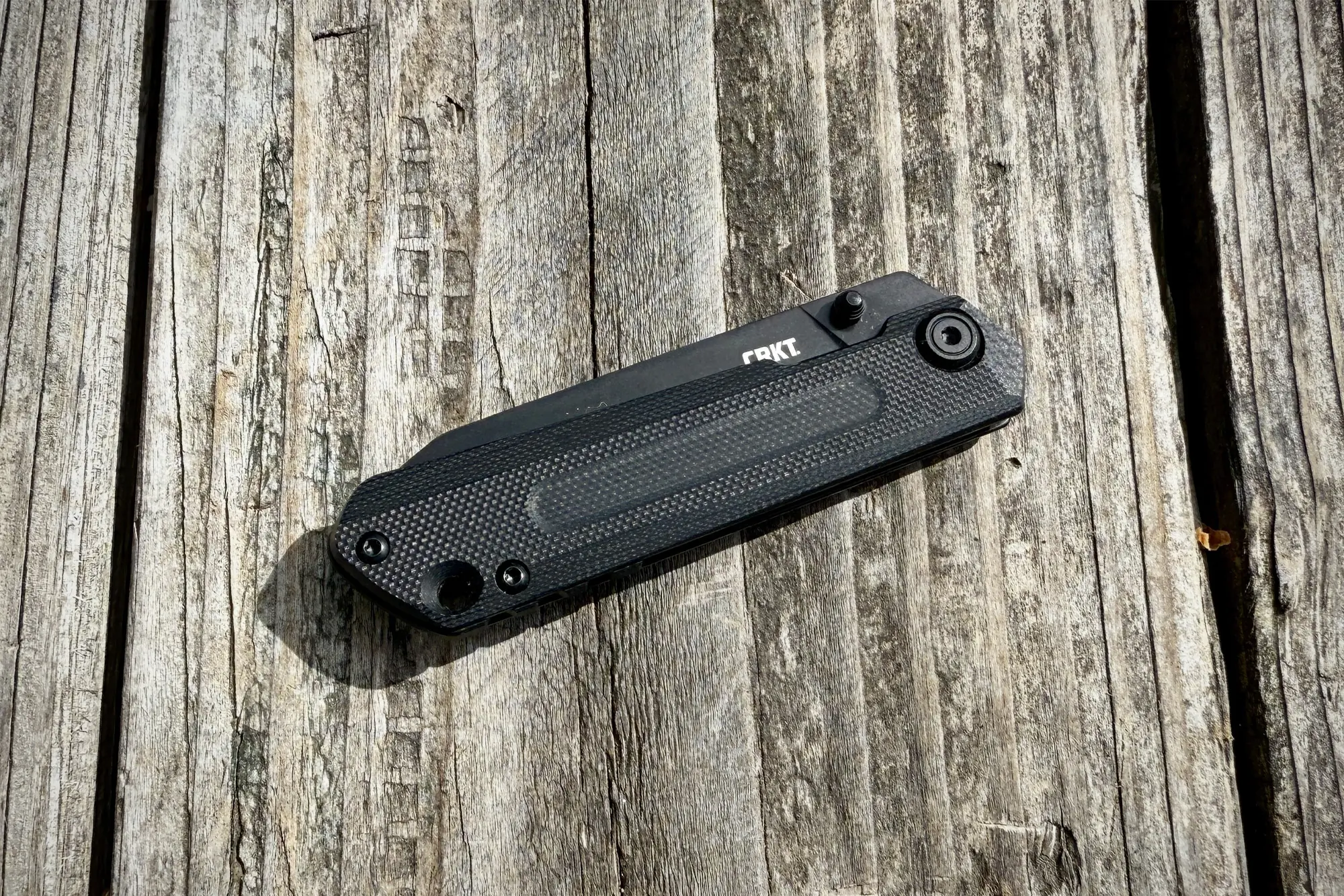 CRKT Straight folded, showing its textured handle and streamlined profile