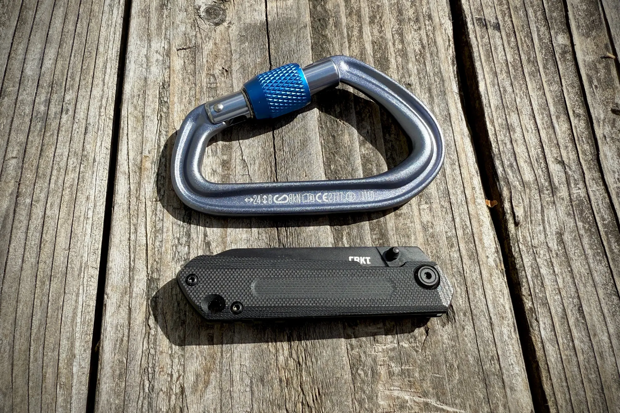 CRKT Straight, folded, next to a locking carabiner for a size comparison
