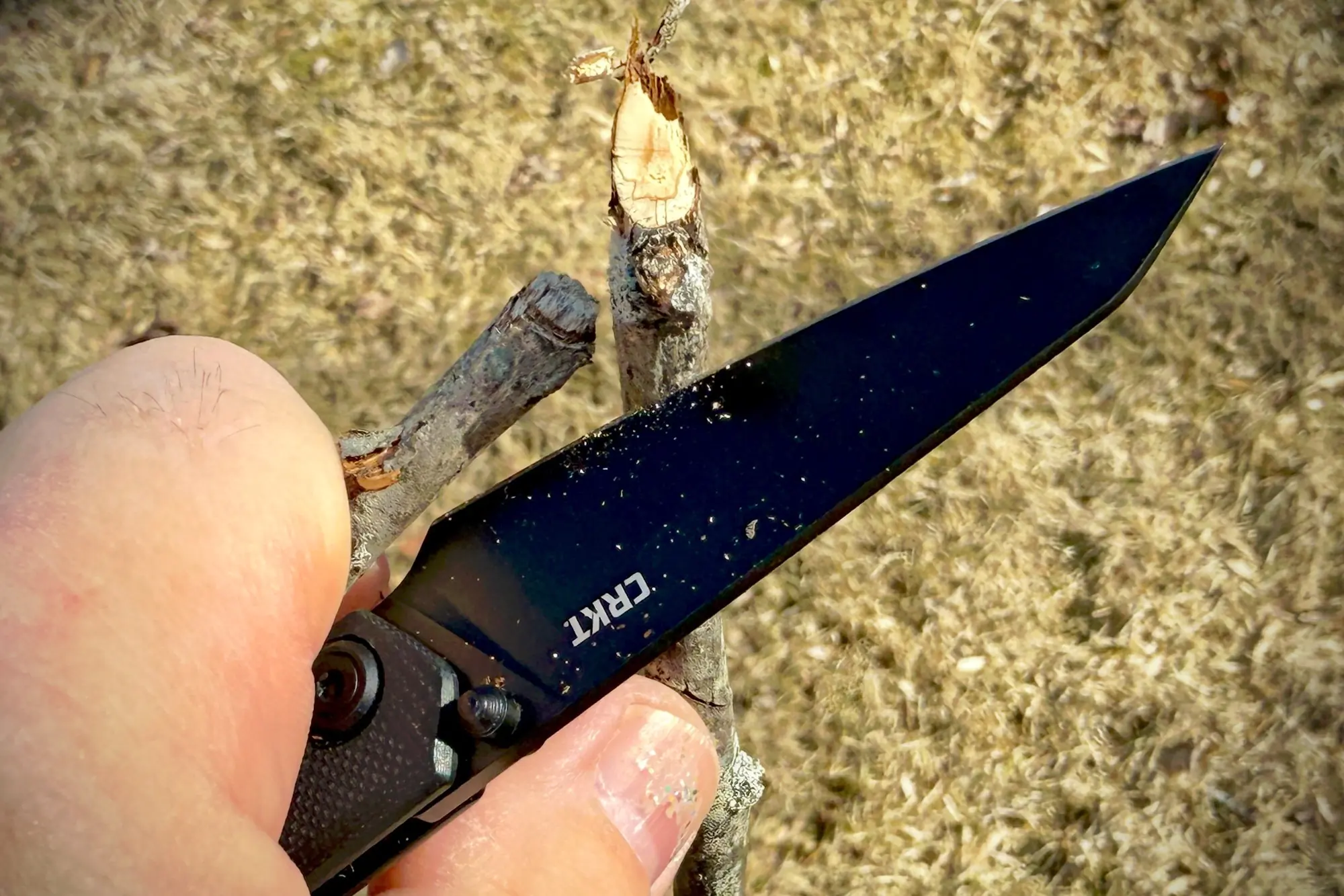 CRKT Straight slicing through a small branch during light trimming work
