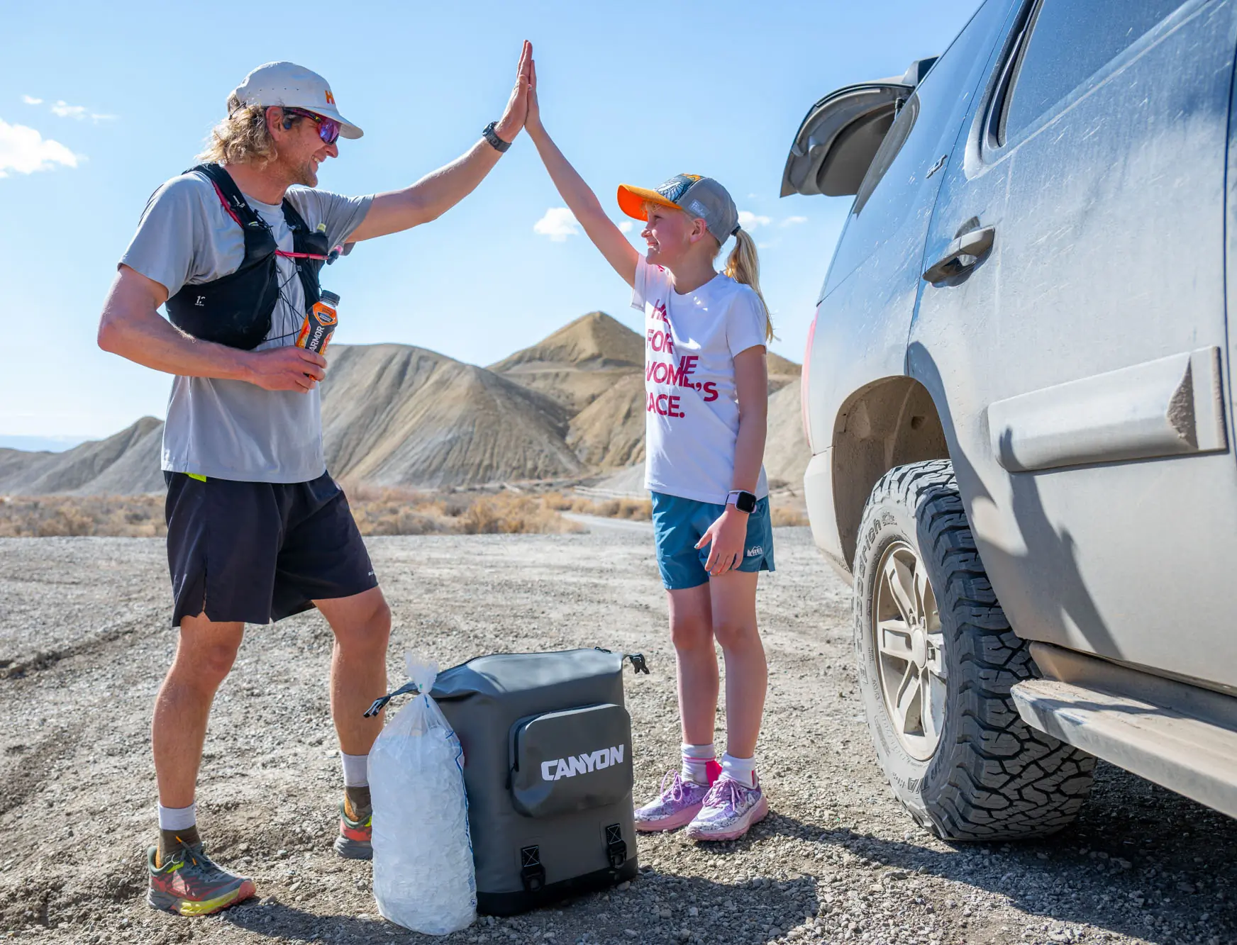 Canyon Coolers Nomad Go Backpack Cooler sitting next to two testers; PC Constance Mahoney