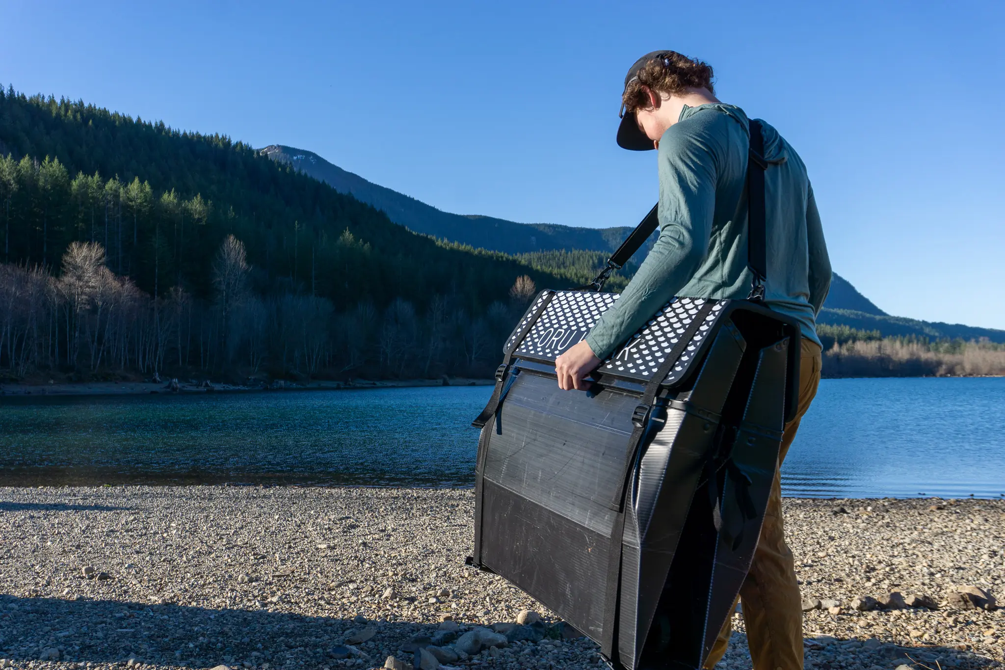 A paddler carries the packed Oru Beach LT Sport to a lake in Washington State