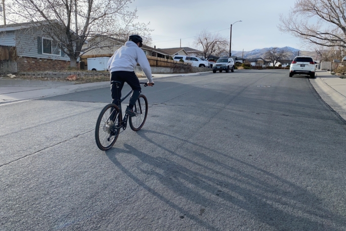 Riding up a paved street through a neighborhood on the Eaglebear Black Everyday bike