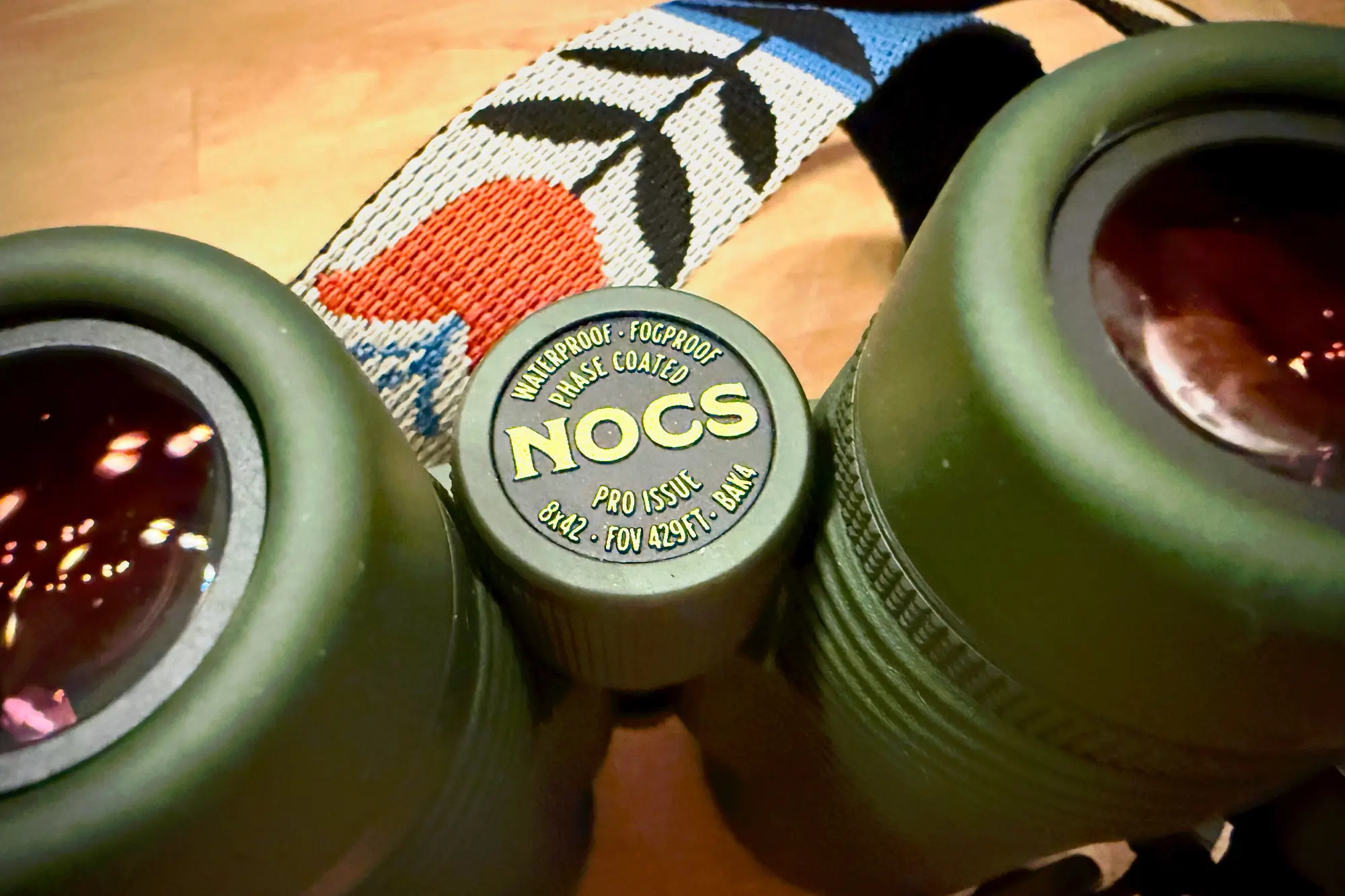 Close-up of the Nocs Pro Issue 8x42 focus dial and lens coatings