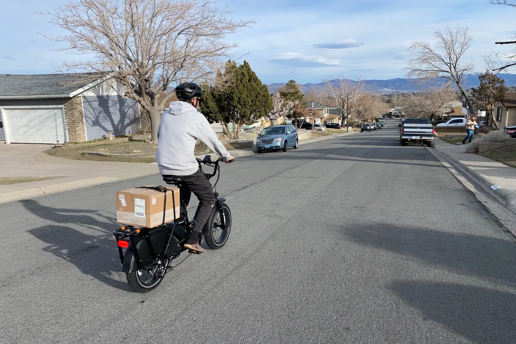 Riding the RadWagon 5 down a residential street with the box strapped to the cargo rack