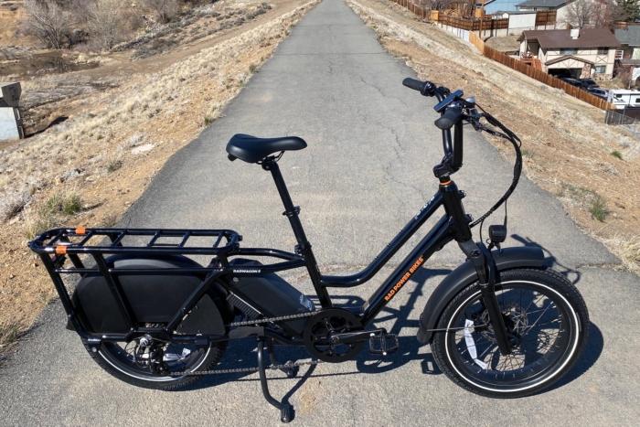 The Rad Power RadWagon 5 electric cargo bike parked on a paved bike path
