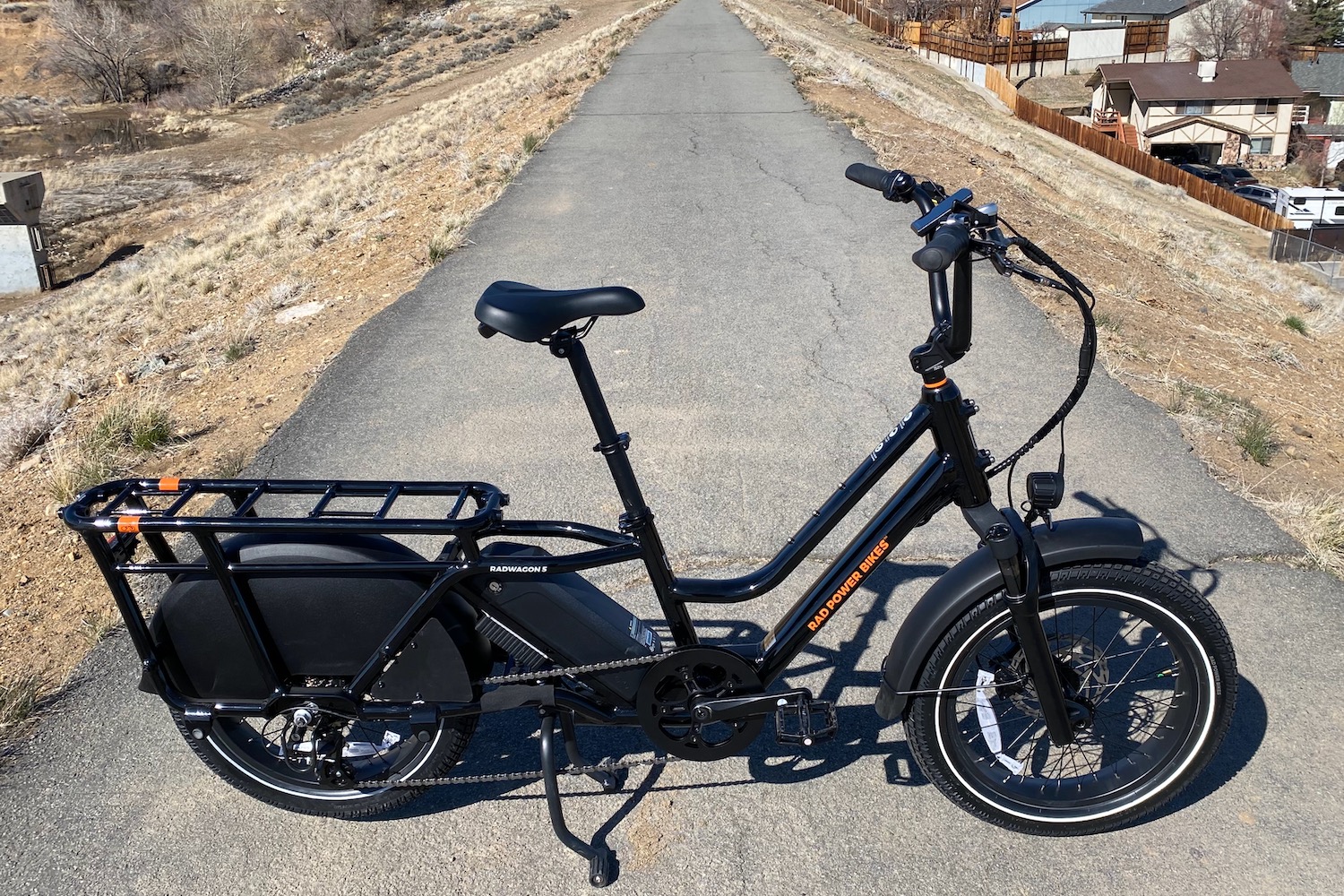The Rad Power RadWagon 5 electric cargo bike parked on a paved bike path