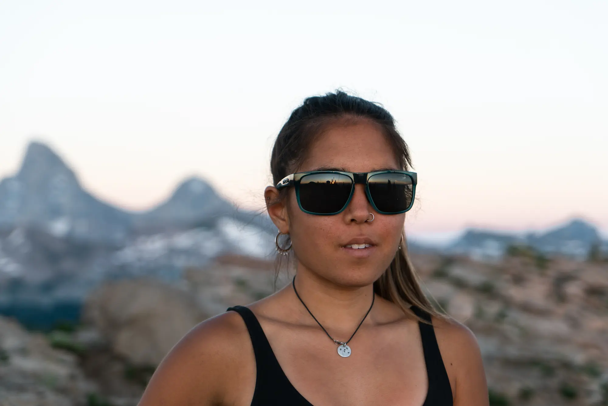 Woman wearing sunglasses in mountains