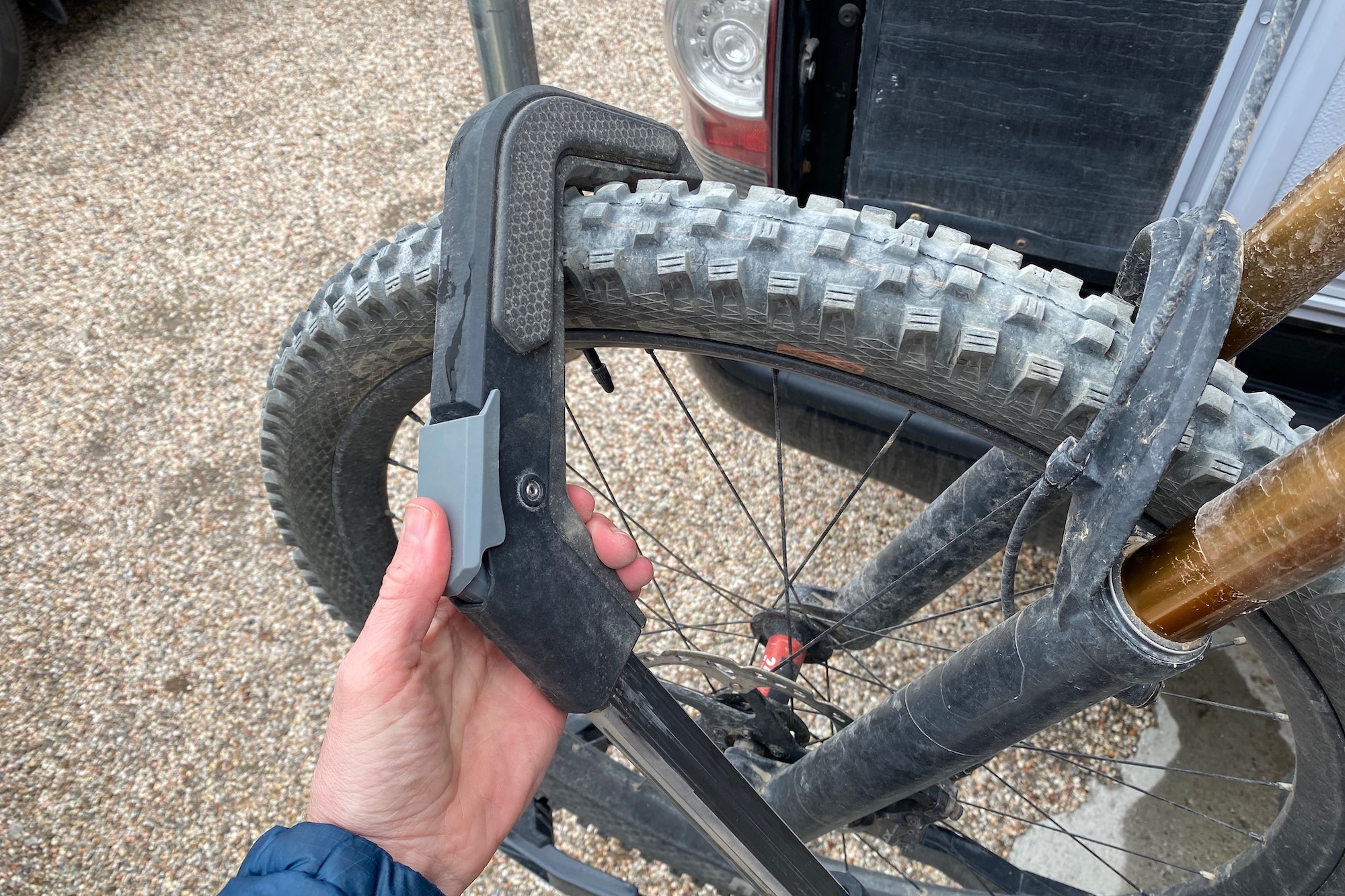Pressing the release button on the front wheel hook of the Edge rack