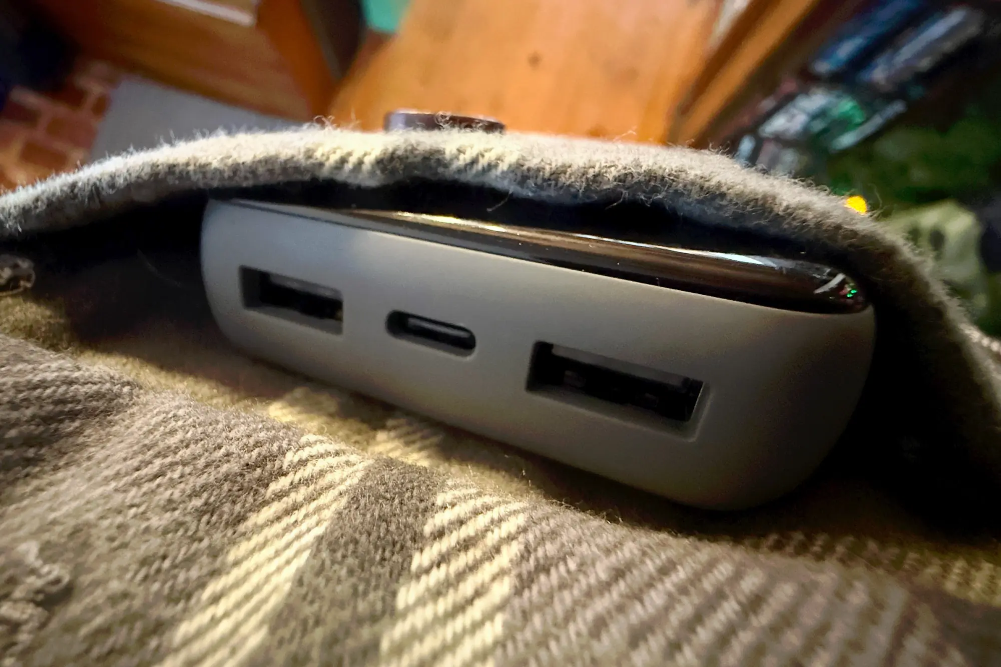 A close-up of the Skullcandy Fat Stash 2 power bank showing its ports, partially covered by fabric