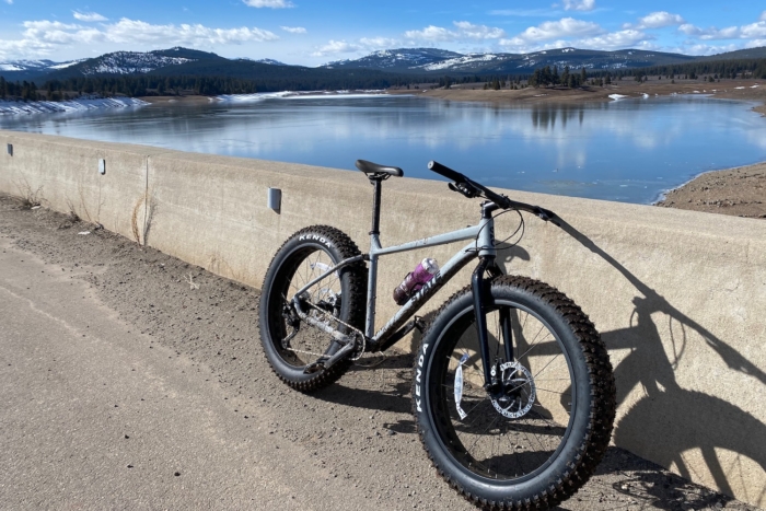 The State 6061 Trail+ Fat Bike parked on a dam by a reservoir during a test ride.