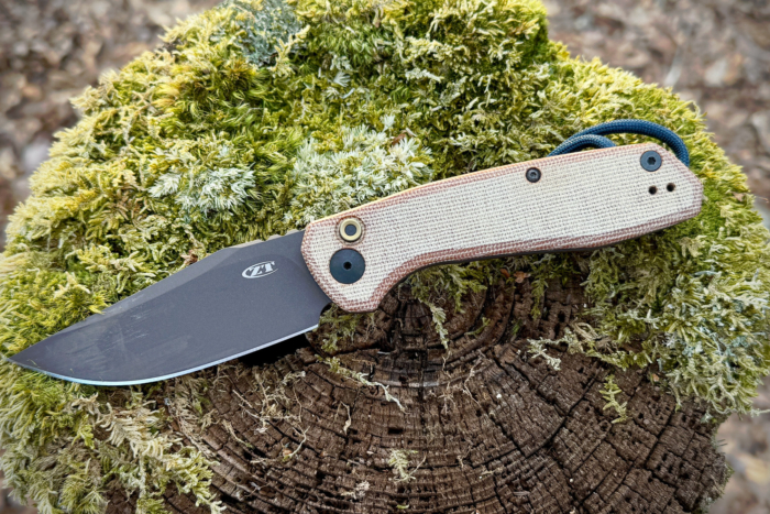 Zero Tolerance 0512: The knife resting on a mossy surface with the blade visible