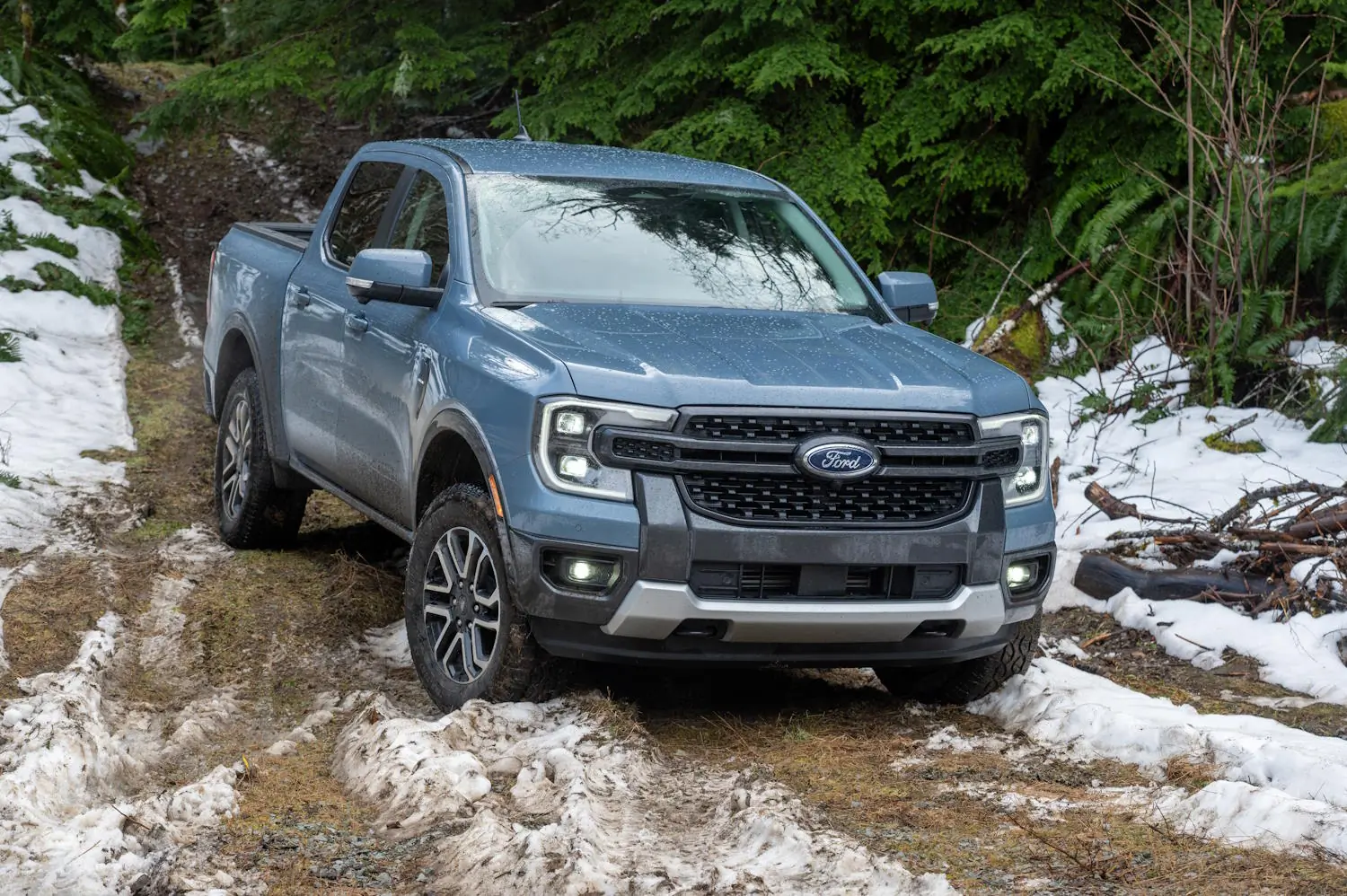 2025 Ford Ranger Lariat 4x4 driving through mud and snow on an off-road trail