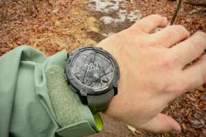 A Garmin Instinct 3 Solar watch displaying a compass heading of 282° (west) on a person's wrist