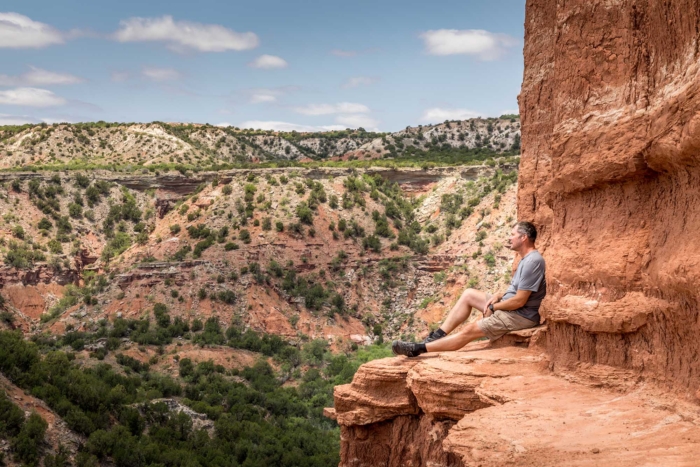 Man,Sitting,On,The,Edge,Of,The,Lighthouse,Rock,,Palo